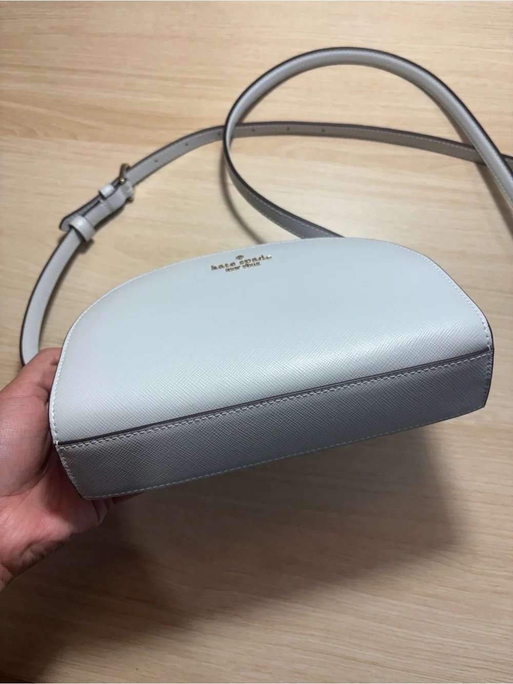 kate spade cream dome crossbody with gold logo